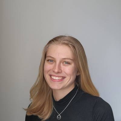 Portrait of Nina Roush in a dark grey blouse with a silver necklace
