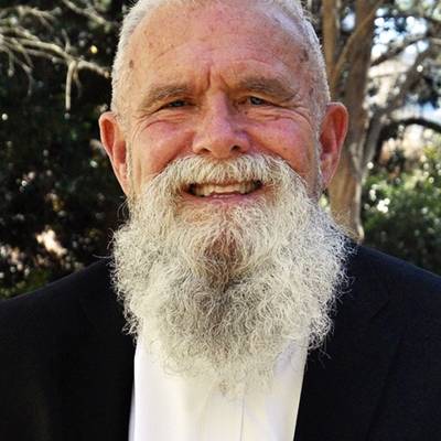 Portrait of Jon Drysdale in a dark blazer and a white dress shirt