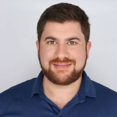 Portrait of Ryann Khalil in a blue polo with a golden bear insignia