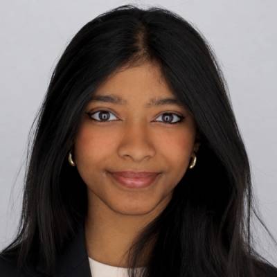 Portrait of Prathyusha Paresh wearing a white t-shirt and a black blazer